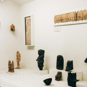 A collection of ancient figurines and artifacts on display in a museum exhibit.