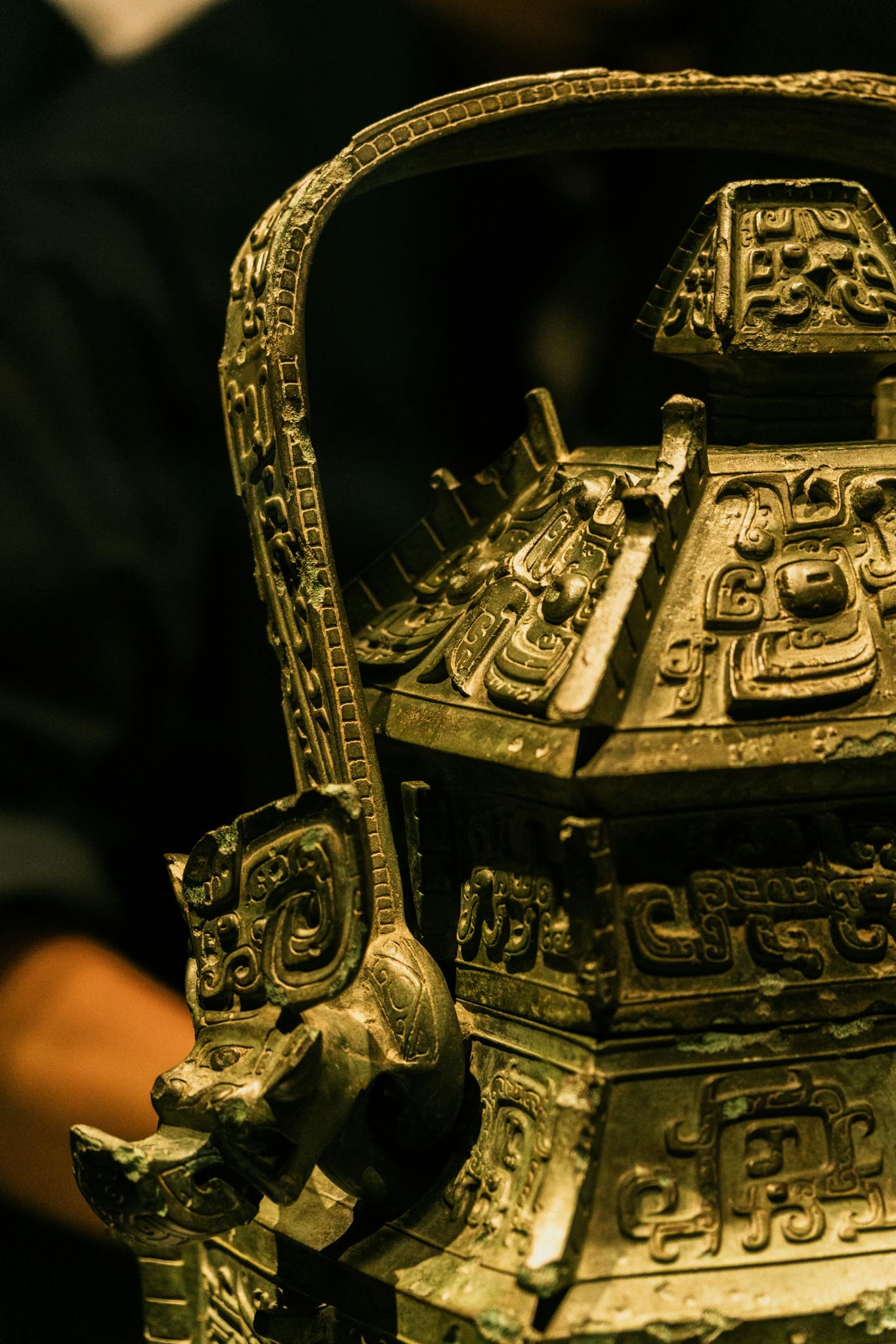 Close-up of a detailed ancient bronze container showcasing elaborate etchings and craftsmanship.