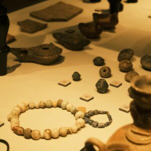 Exhibit of ancient artifacts including pottery and jewelry in a museum.