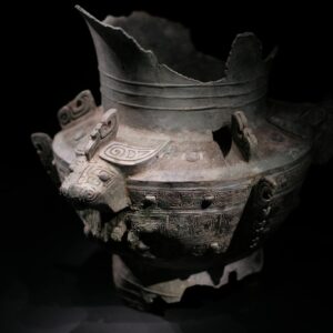Intricate ancient Chinese bronze vessel with decorative patterns and animal motifs on display.